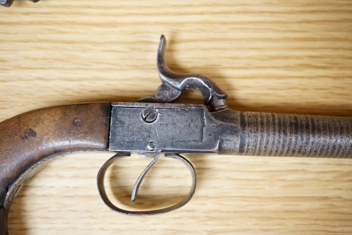 A boxlock percussion pocket pistol with turn off barrel inlaid with spiral brass wire for full length, plain frame and rounded walnut grip, probably Belgium made